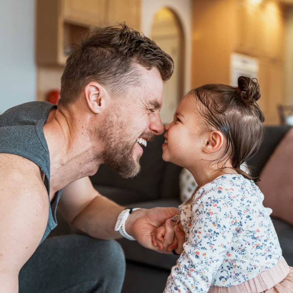 Father playing with his daughter in their home at Ruby Vista in Denver, Colorado