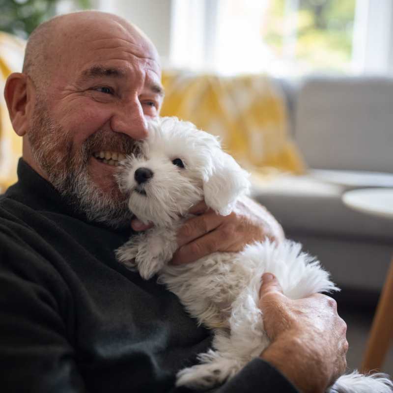 A happy resident holding his puppy at Rockwood Park, North Chesterfield, Virginia