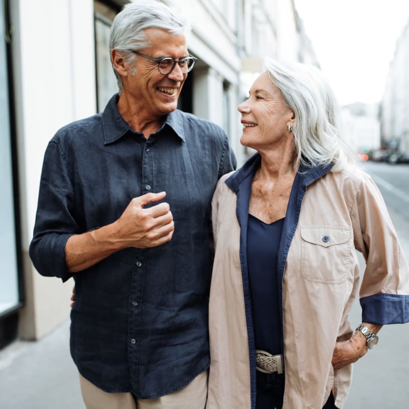 older couple of residents walking together at Station 16 in Millbrae, California