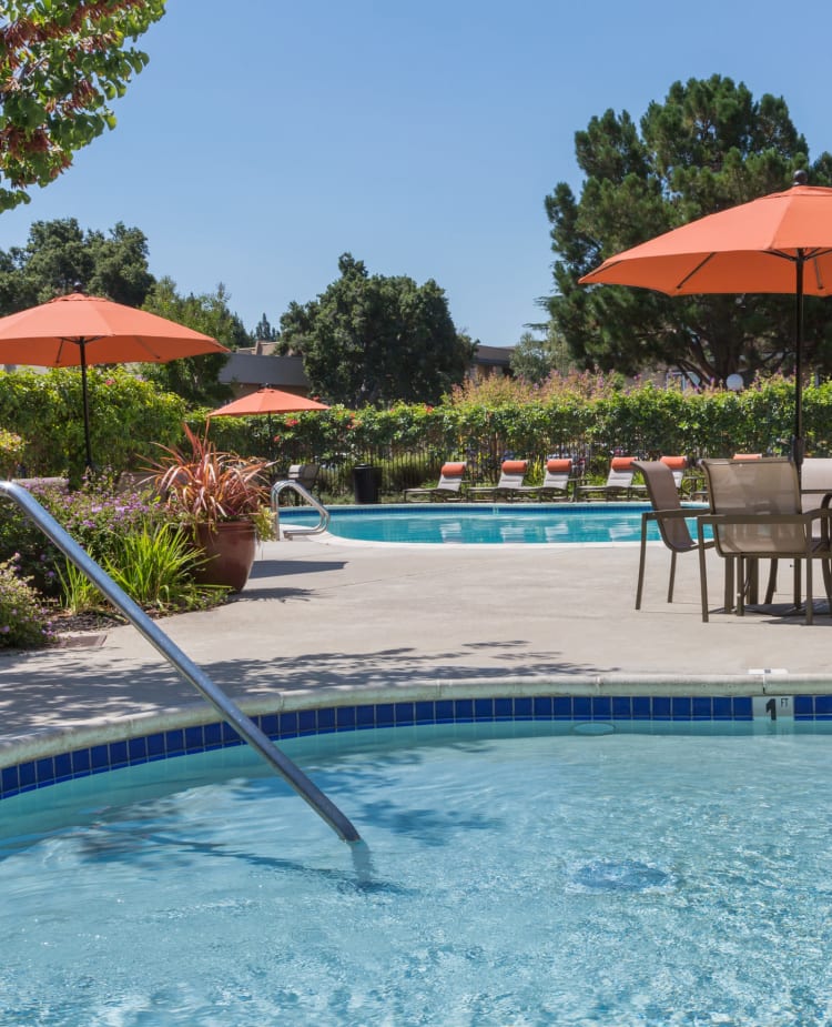 Children's wading pool with shaded tables and chairs nearby at Waterstone Fremont in Fremont, California