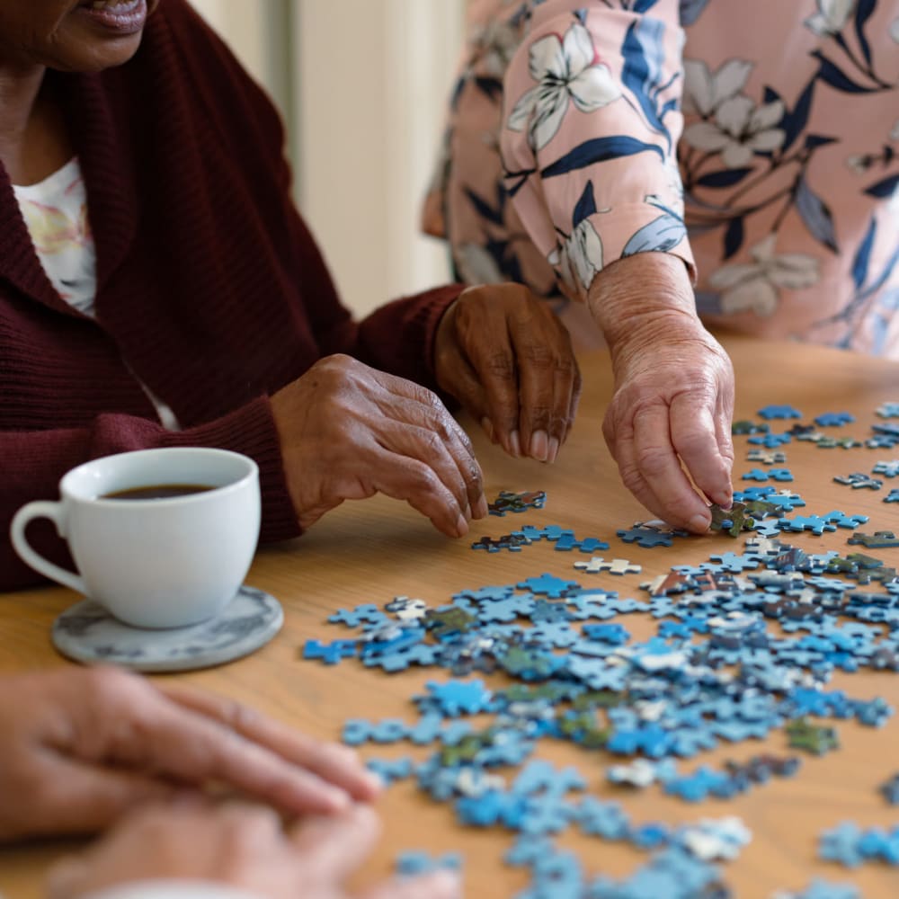 Residents doing a puzzle at The Peaks at South Jordan Memory Care in South Jordan, Utah