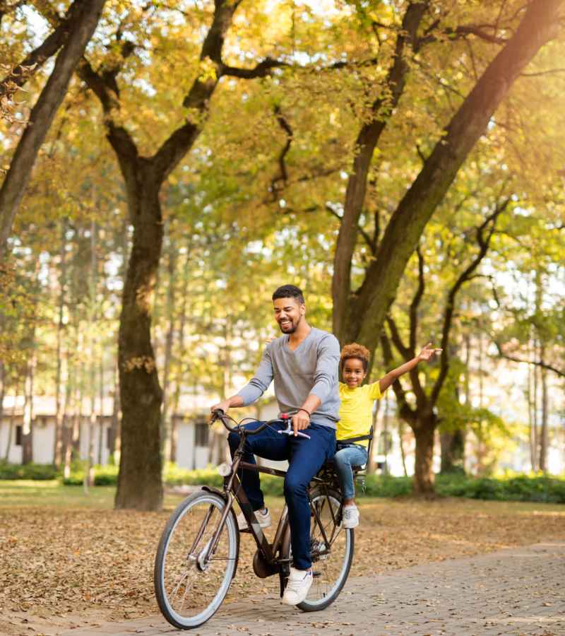 A father and his daughter enjoying their ride on a bicycle in a park nearby Prosper 83 in Sparks, Nevada