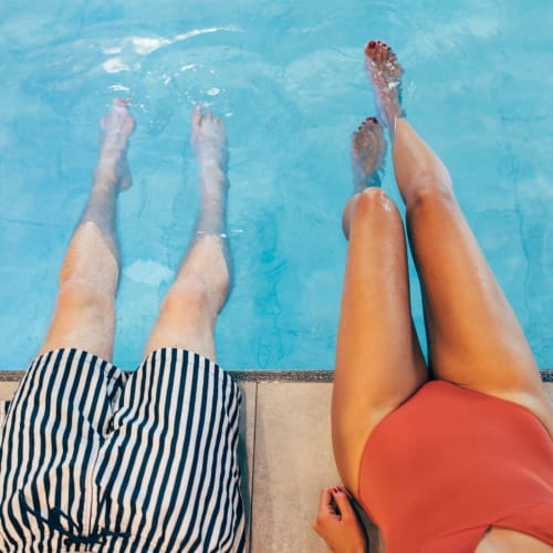 Couple sitting poolside at Solaire 8250 Georgia in Silver Spring, Maryland