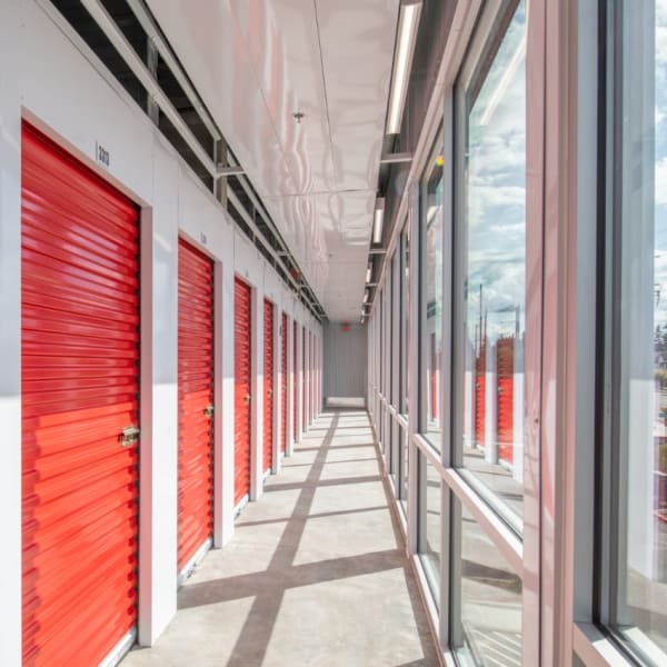 Indoor storage units with bright red doors at StorQuest Self Storage in Santa Clarita, California