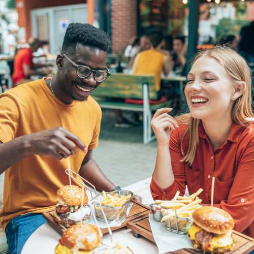 A couple of friends having food in a restaurant near Stone Village Apartments in Reno, Nevada