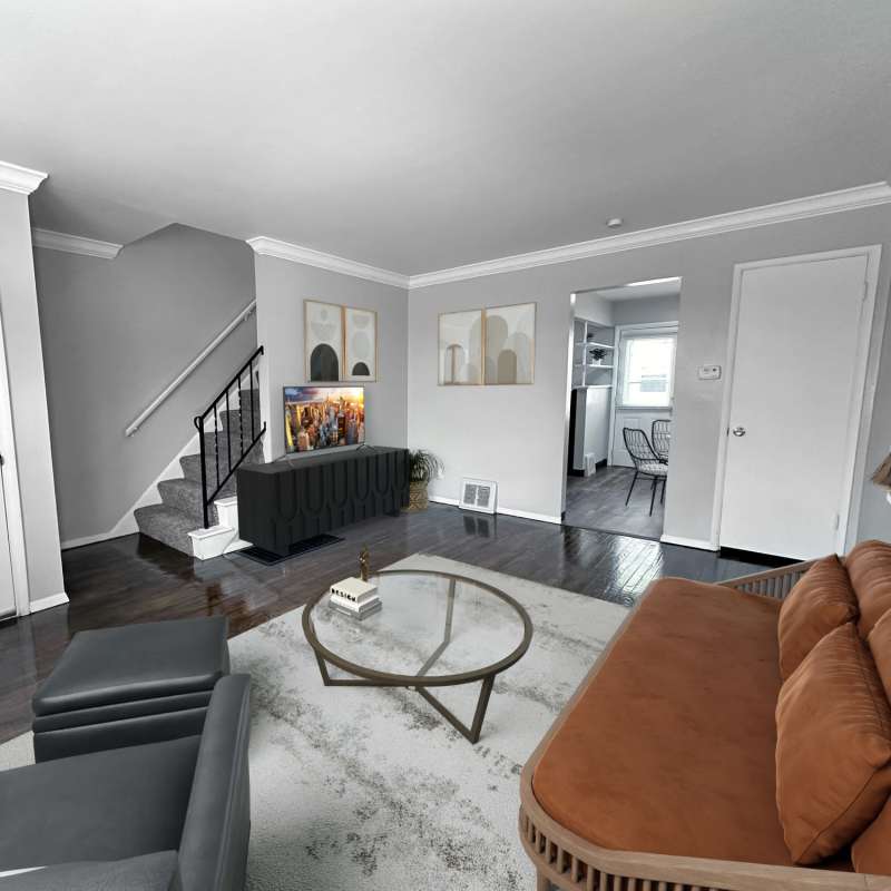 Living room with staircase at Eden Green Townhomes in Columbus, Ohio