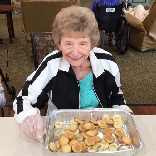 Resident blowing bubbles at Oxford Glen Memory Care at Grand Prairie in Grand Prairie, Texas