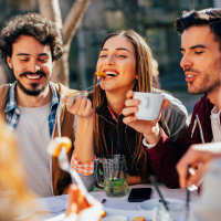 A group of students having lunch at McCart Apartment Homes in Fort Worth, Texas