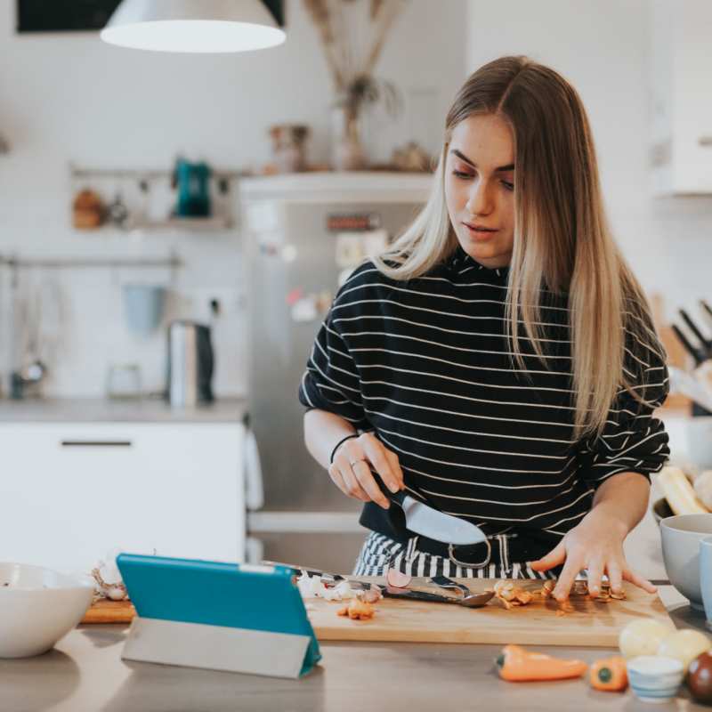 Resident chopping vegies while learning how to cook in the kitchen at Heron Creek Apartments in Moses Lake, Washington