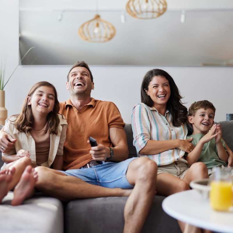 Happy residents in their living room at Fidelis Willis in Willis, Texas