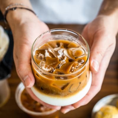 Resident holding an iced coffee near Walnut Creek Apartments in Macon, Georgia