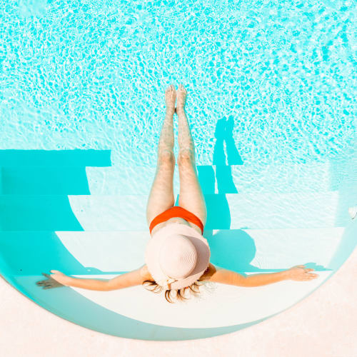 A resident relaxing in the swimming pool at Fairway Heights in Twentynine Palms, California