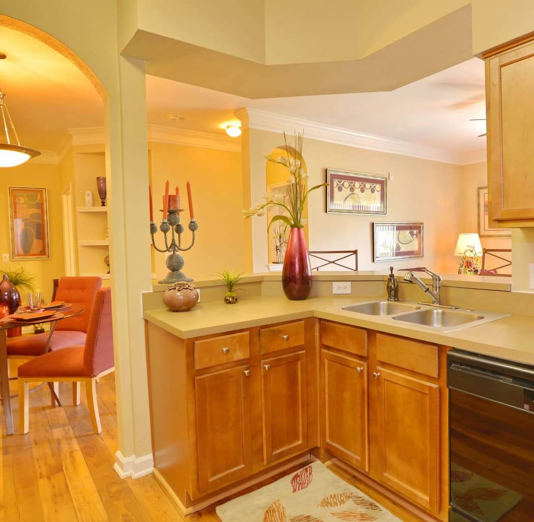 View of dining area with custom chandelier from modern kitchen in model home at IMT Kingwood in Kingwood, TX