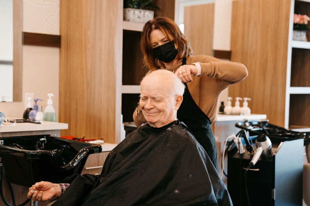 Senior man getting his hair cut at Pillars Senior Living in Lakeville, Minnesota
