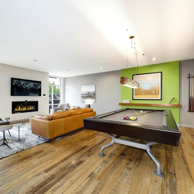 Pool table and big couch in front of a tv in the resident clubhouse at Alley South Lake Union in Seattle, Washington