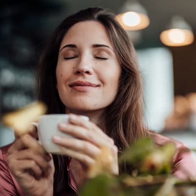 Woman enjoying coffee at a cafe near 17 Barkley in Gaithersburg, Maryland