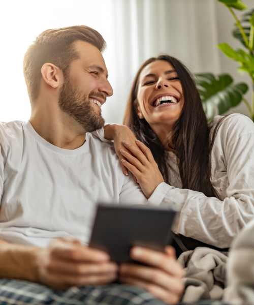 Resident couple relaxing in living room at District at 54 in Raleigh, North Carolina