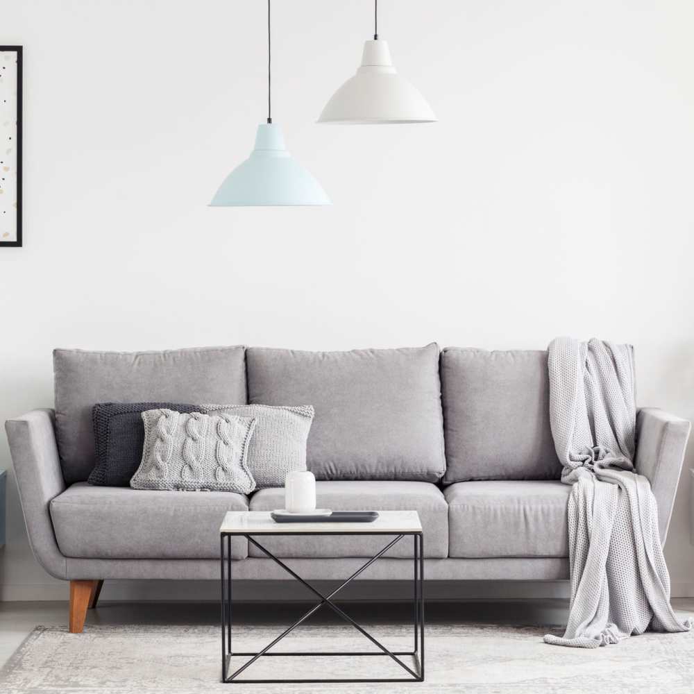 Living room with large sofa and window at The Simone in Silver Spring, Maryland