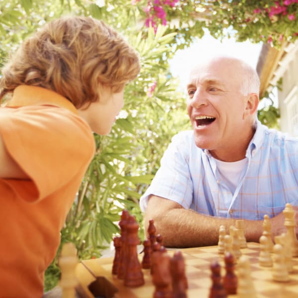 A man and his grandson playing chess at Pacifica Senior Living Santa Rosa in Santa Rosa, California