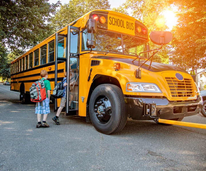 Children boarding school bus at Camas Meadows in Beaverton, Oregon