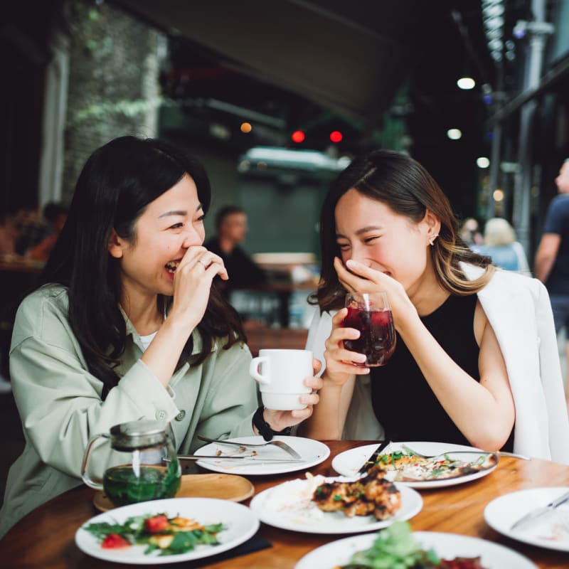 residents laughing while eating out  near  Station 16 in Millbrae, California