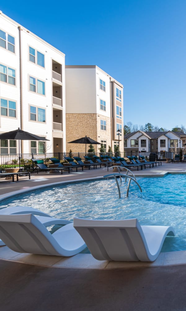 Gorgeous resort-style swimming pool with sundeck lounge seating at The Reserve at Patterson Place in Durham, North Carolina