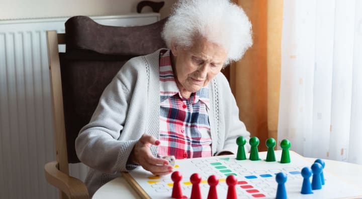 Senior woman playing board game