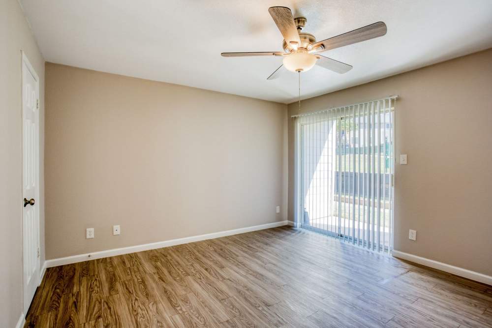 Apartment with plank flooring and access to balcony at The Summit Apartments in Athens, Texas