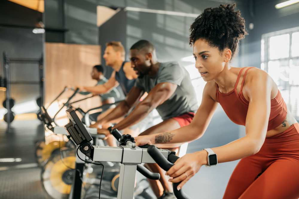 Residents cyclying in the fitness center at Seven17 Lehman in Houston, Texas