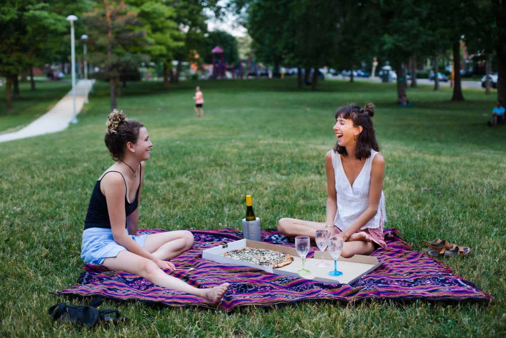Residents enjoying pizza together outside at Palm Manor Apartments in McAllen, Texas