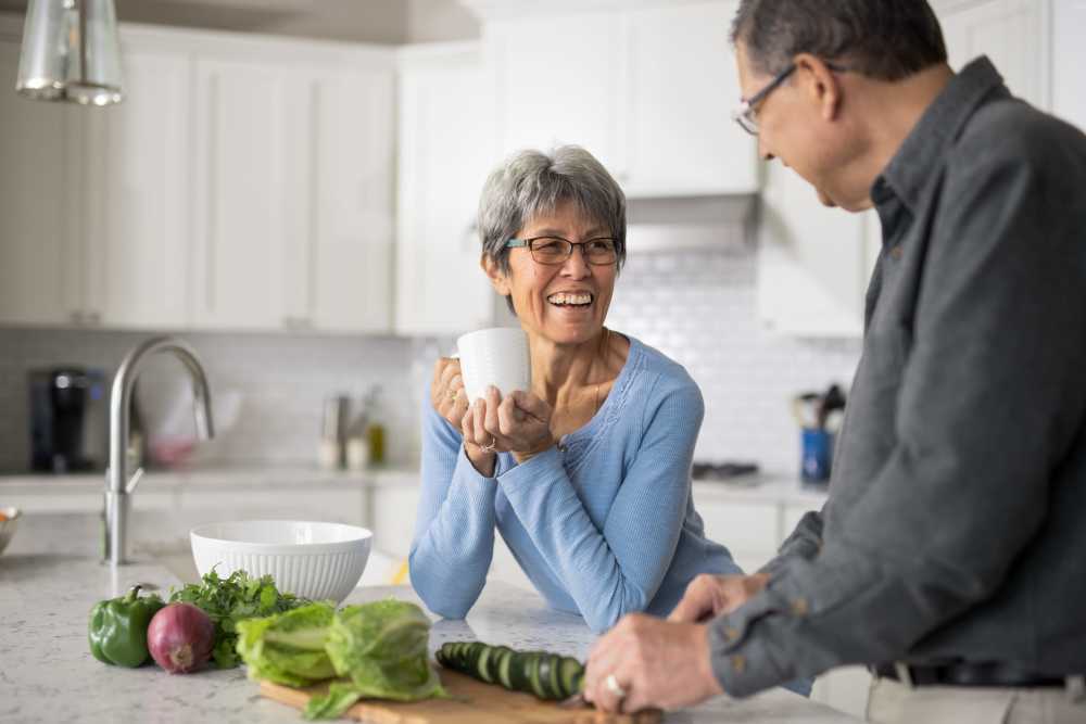 Couple having conversation in kitchen at Pa'anau Village I in Koloa, Hawaii