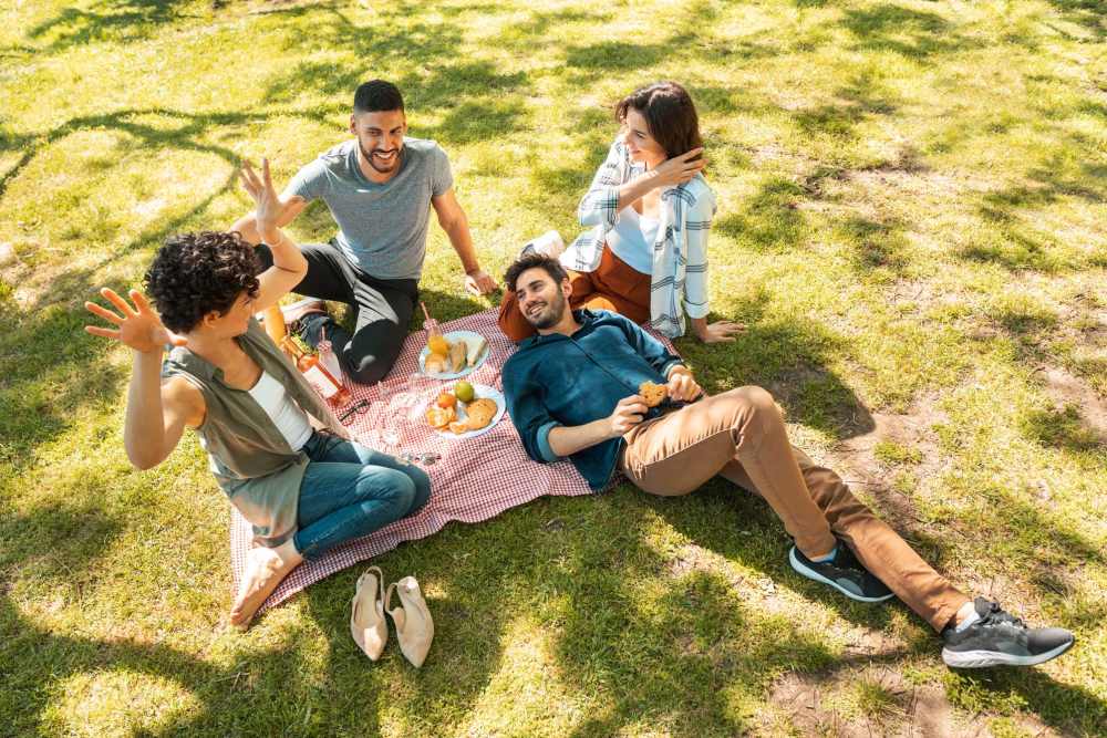 Resident friends relaxing in the park at Fall Creek View Apartments in Indianapolis, Indiana