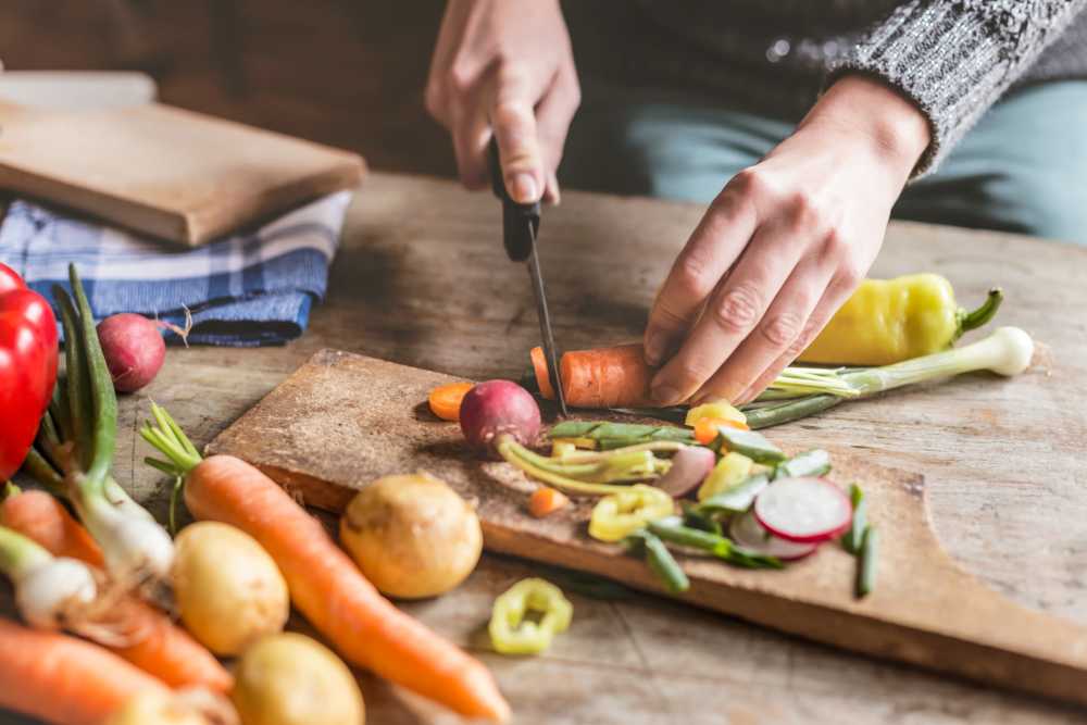 Resident cutting vegetables at 275 Chestnut Supportive Housing in Springfield, Massachusetts