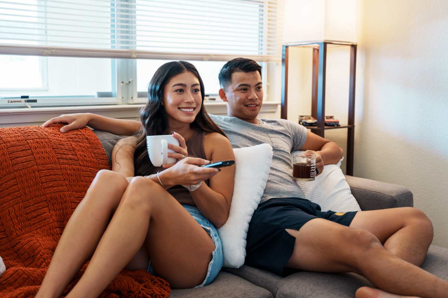 Couple watching tv on the couch at Manistique Lakeview in Manistique, Michigan