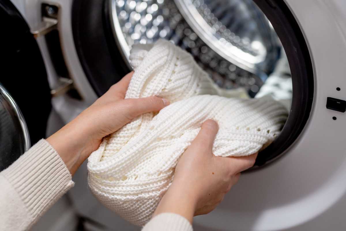Woman taking her laundry from the washer at One West End in Charlotte, North Carolina