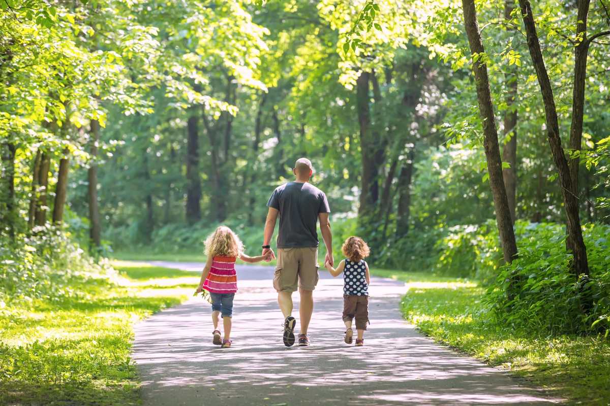 A resident man with his children at a park at Parkland Village in District Heights, Maryland