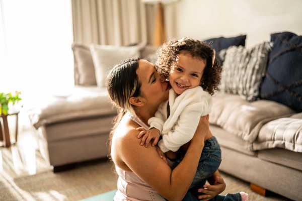 Mother and her daughter playing in the living room at Raystone Apartments in Phoenix, Arizona