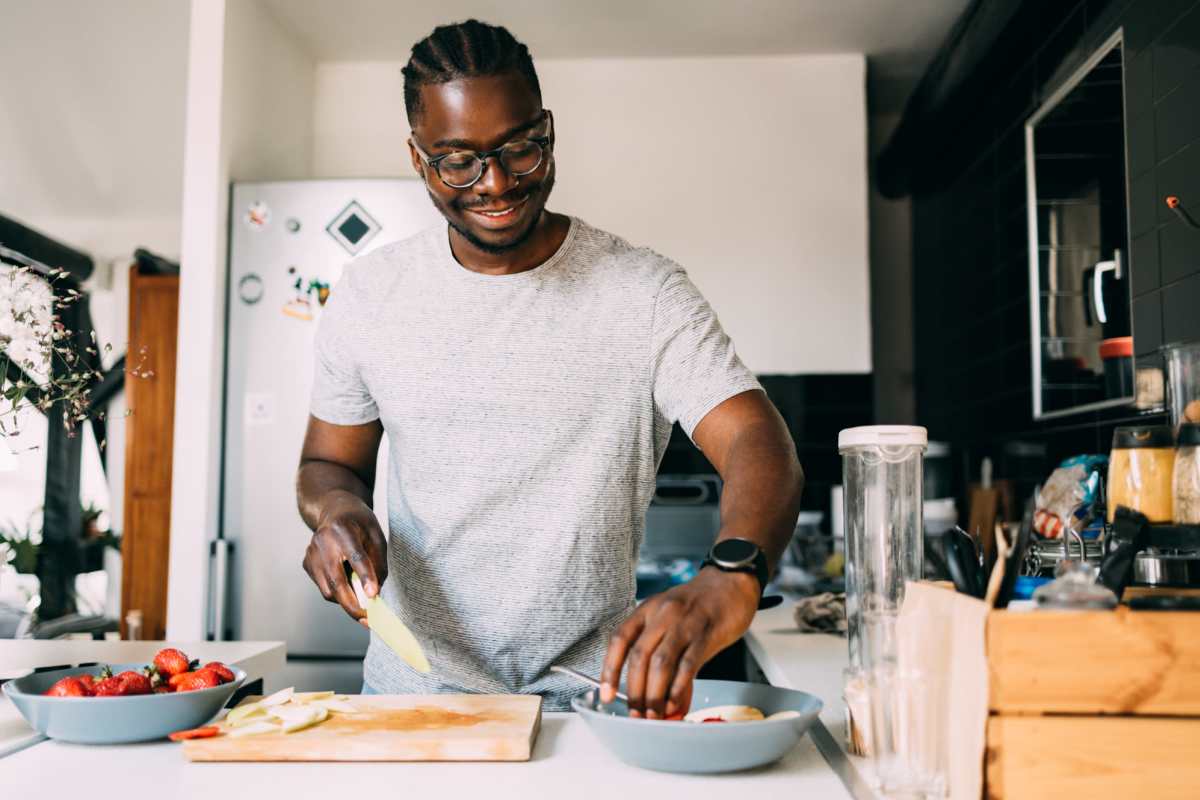  Resident chopping vegetables in the kitchen at Pinehurst Villas in Orange, Texas