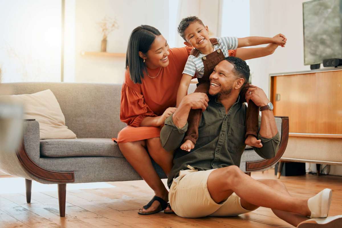 Happy family in living room at Timber Village in Marshall, Texas