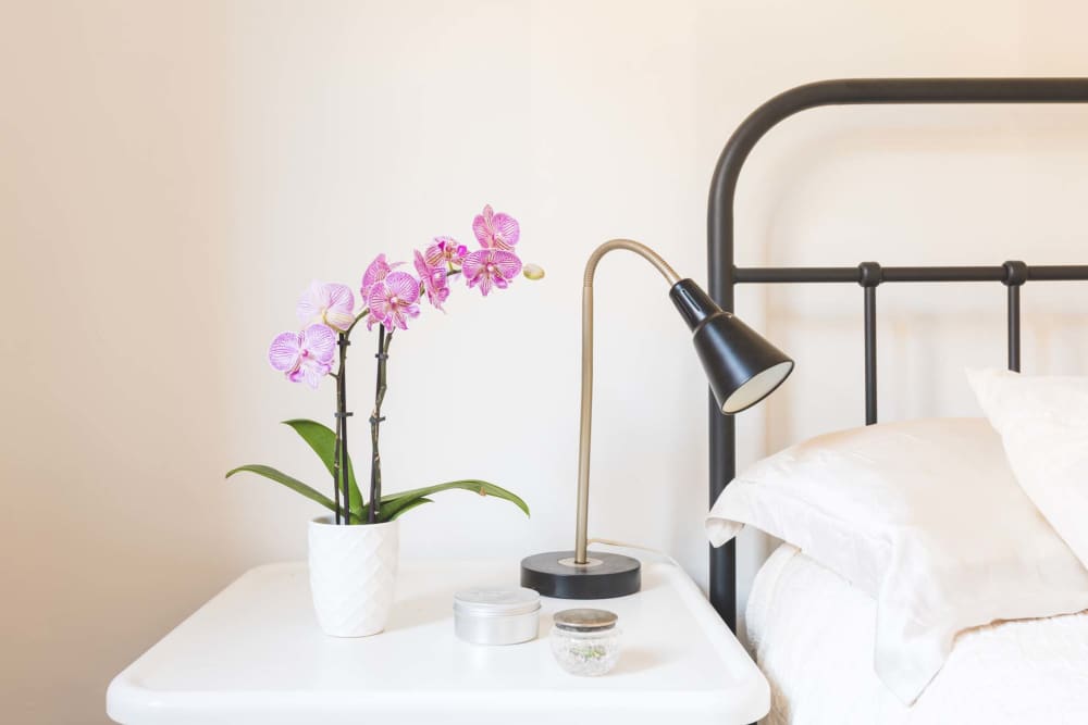 Bedroom with side lamp at Reeds Landing Apartments in Edmond, Oklahoma