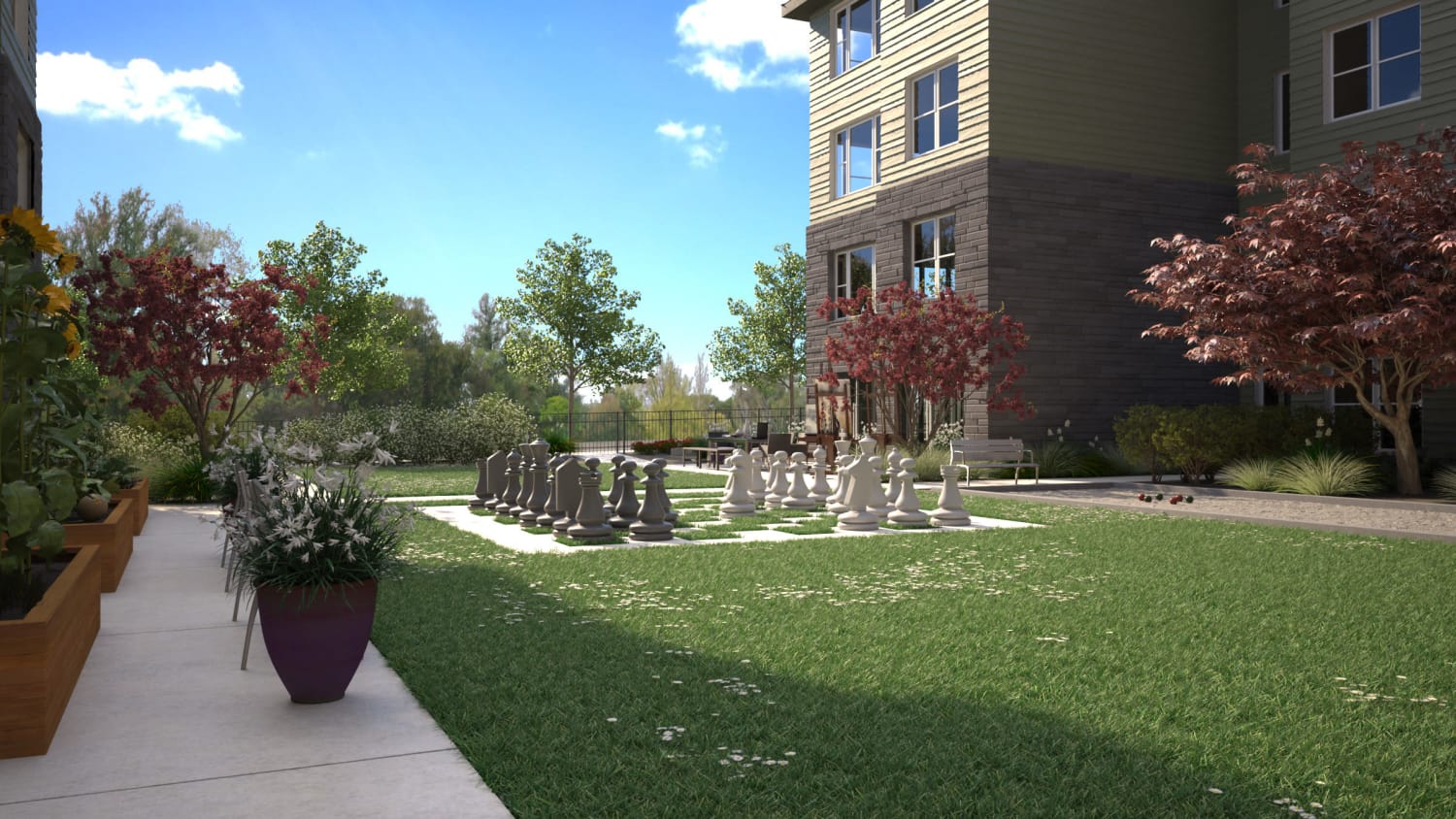 Spacious outdoor areas at Avenida Lakewood senior living apartments in Lakewood, Colorado, featuring a large chess table. 