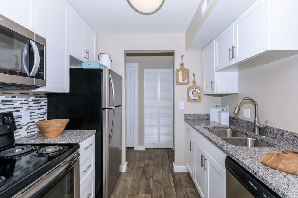 Couple cooking together in their full-equipped modern kitchen at Lakeside Crossing at Eagle Creek in Indianapolis, Indiana