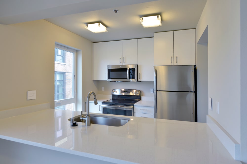 Kitchen with stainless-steel appliances at 2900 on First Apartments in Seattle, Washington