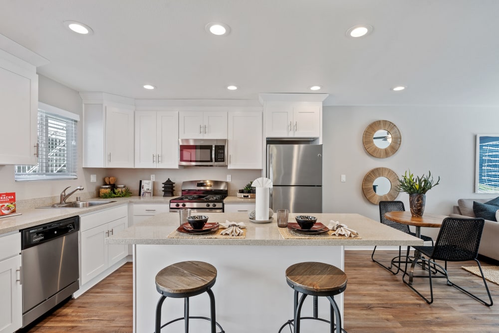 Kitchen with chef's island and bar seating at Pinebrook Apartment Homes in Fremont, California