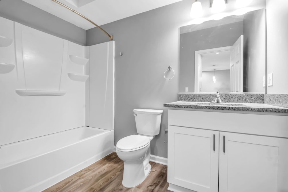 Bathroom with wood panel flooring at Creekview Court in Getzville, New York