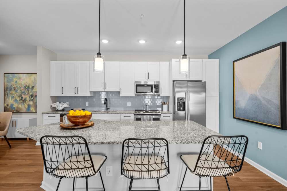 Apartment kitchen with a breakfast counter and fancy chairs at North Bay Landing in Panama City,Florida