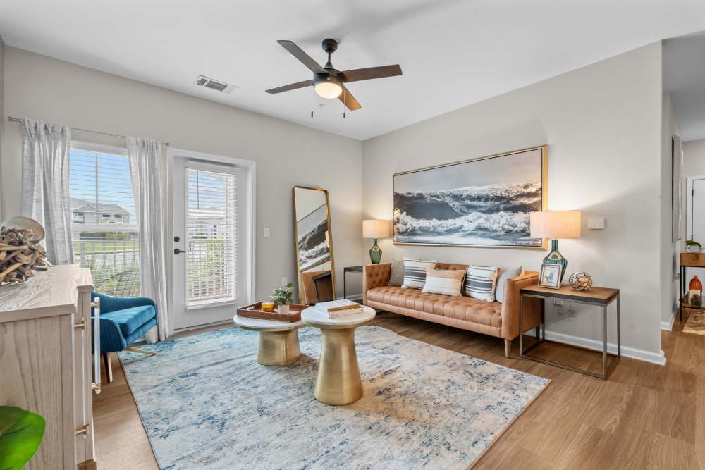 Spacious living room with trendy furniture and fancy ceiling fan at North Bay Landing in Panama City,Florida