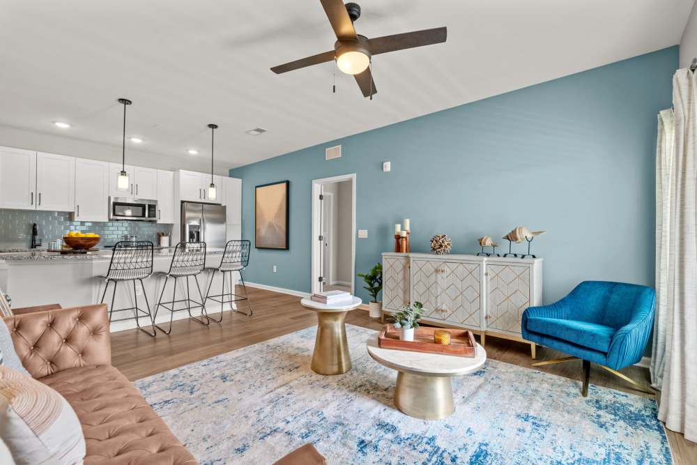 Classy apartment living room with granite countertop and hardwood flooring at North Bay Landing in Panama City, Florida