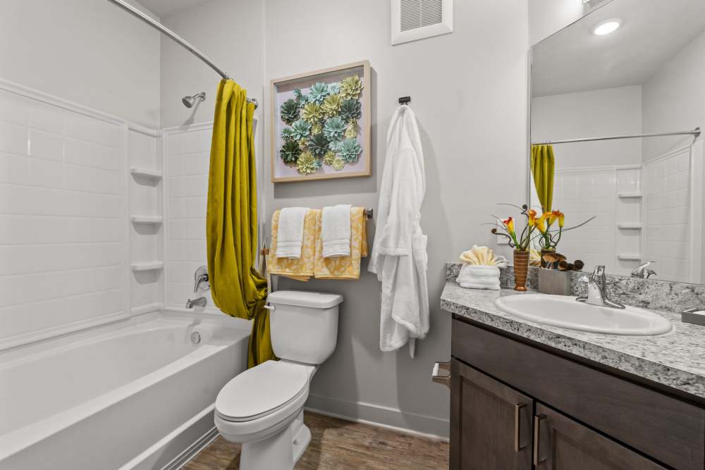 Bathroom with soaking tub and granite counter at Pier Park Crossings.