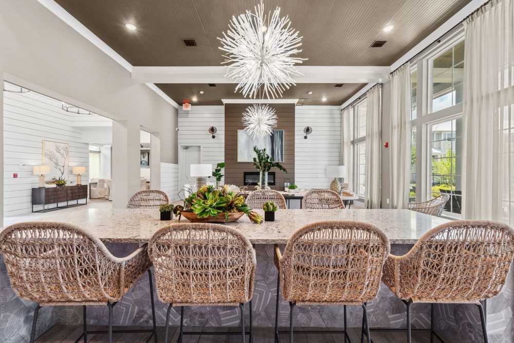 Event center with chairs and large granite counter at Pier Park Crossings Apartments.